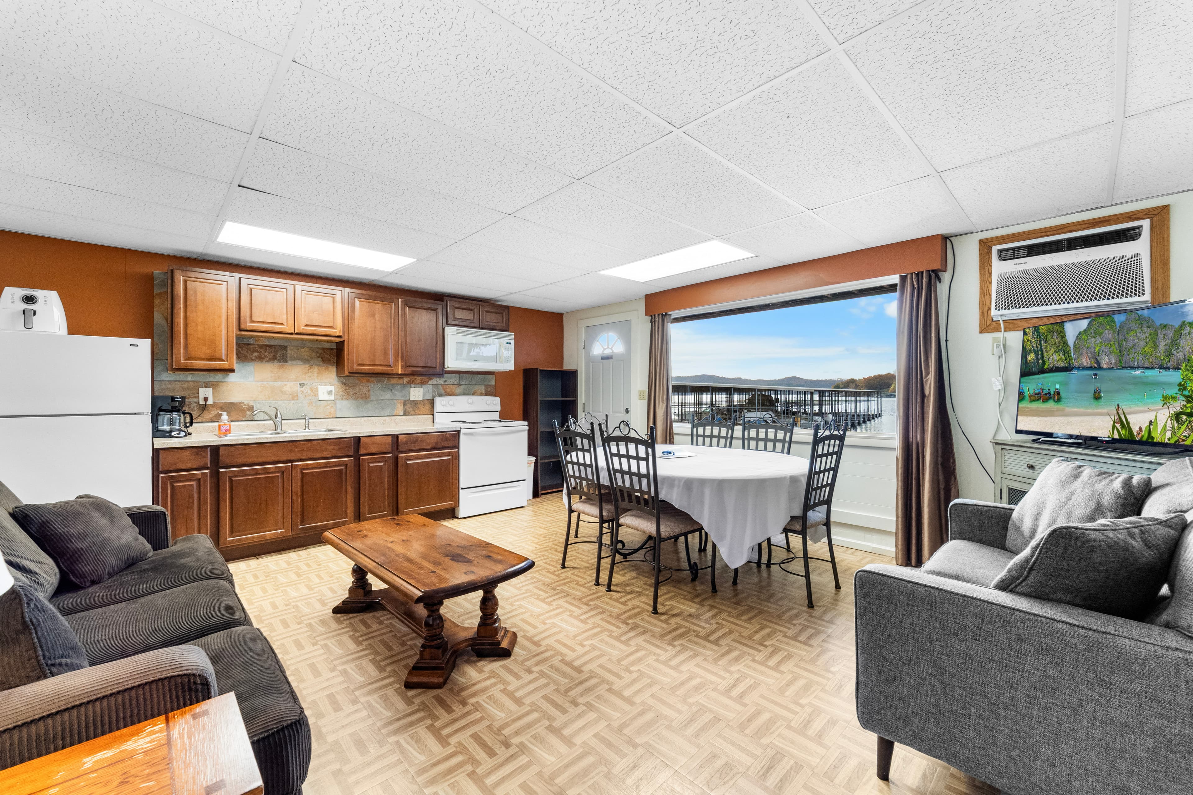 A cozy kitchen and dining area with a view of the lake, featuring a table, chairs, and comfortable seating.