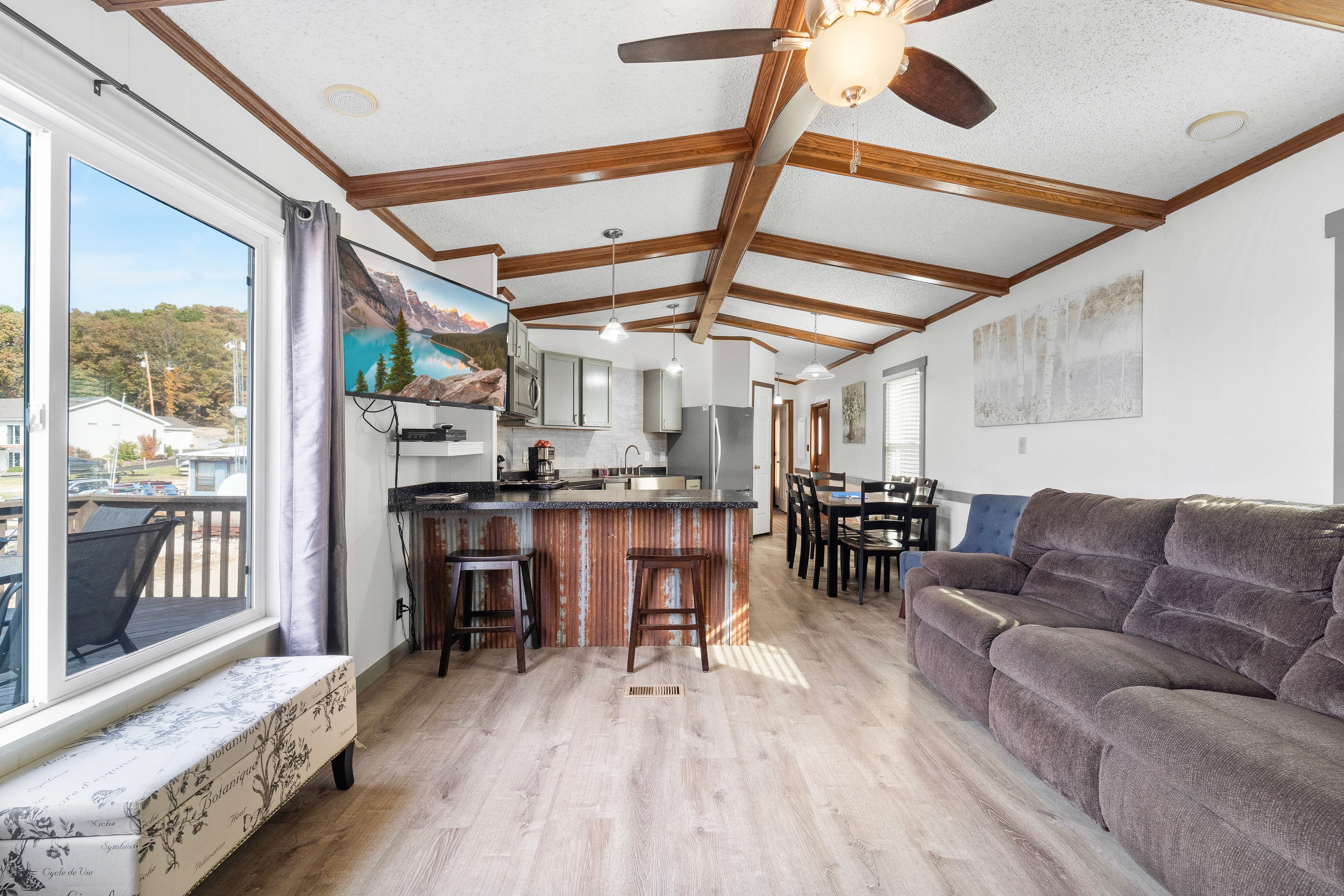 Bright, modern open-concept living area with a kitchen, dining space, and comfortable seating.