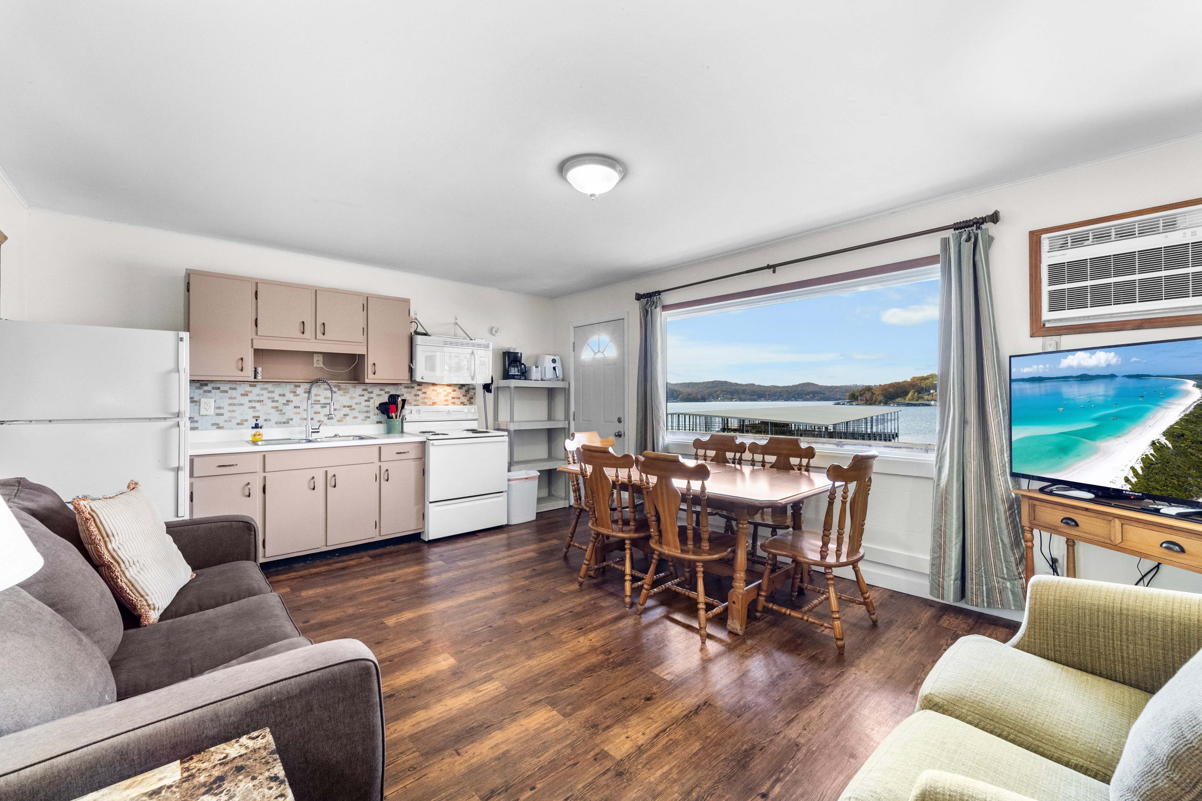 A cozy open-concept kitchen and dining area with a view of the lake.