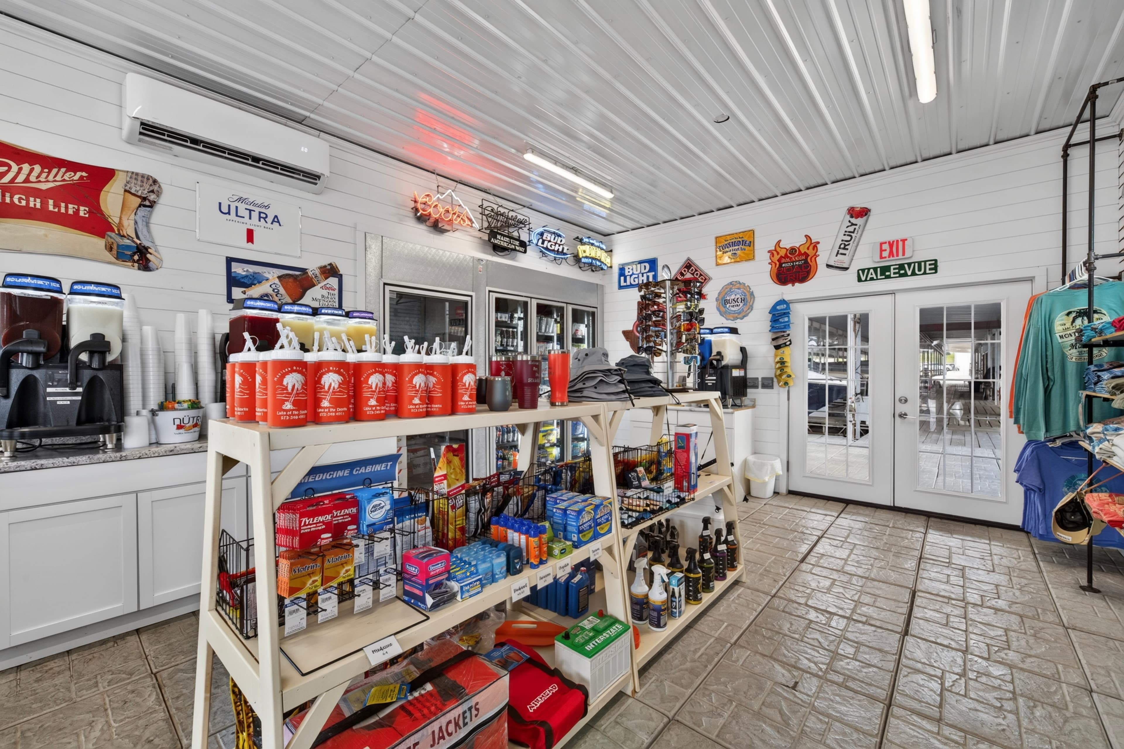 Interior of a convenience store displaying shelves of snacks, beverages, and merchandise, with various signs on the walls.